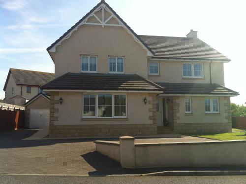 a large house with a large roof at Taigh d'Luxe in Inverness