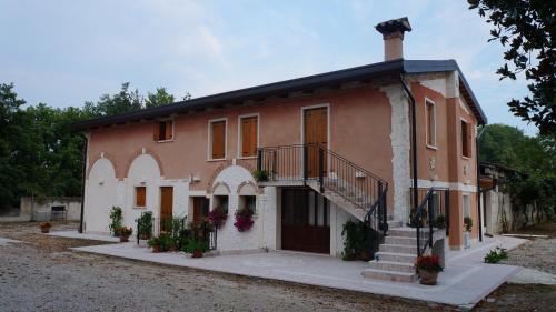 a large house with a porch and stairs on it at Agriturismo Da Gas in San Giorgio in Bosco