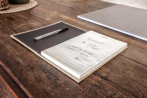 a pen sitting on top of a notebook on a table at Giardini Acantus in Rosolini