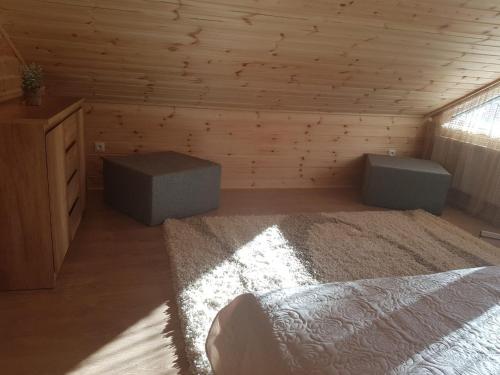 a bedroom with a bed and a dresser and a window at Advance in Narva-Jõesuu