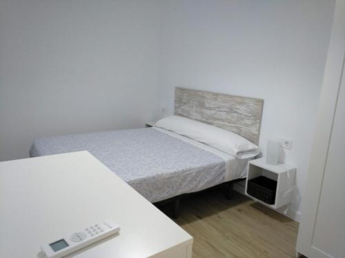 A bed or beds in a room at Apartamentos Angelita Plaza Beach