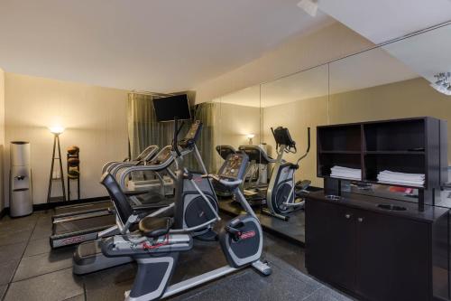 a gym with three exercise bikes and a flat screen tv at Wingate by Wyndham Goodlettsville in Goodlettsville