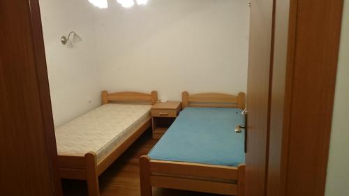 two beds in a room with a door open at BG Villa, Apartment L in Sutomore