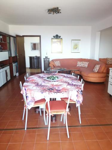 a living room with a table and chairs and a couch at Casa Romeo in Taormina
