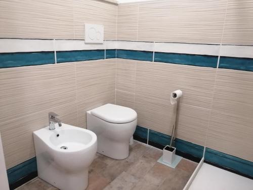 a bathroom with a toilet and a bidet at Casa Romeo in Taormina