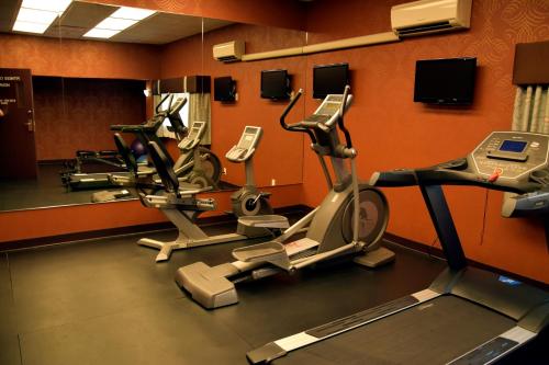 a gym with two exercise bikes and a mirror at Coast Lethbridge Hotel & Conference Centre in Lethbridge