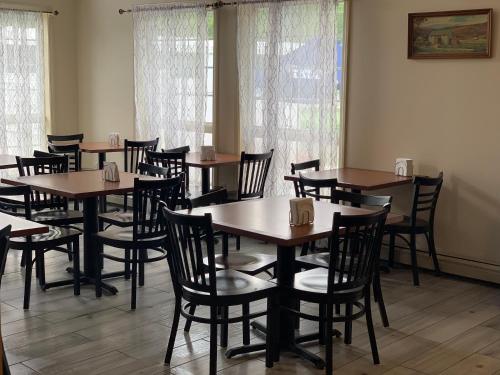 a dining room with wooden tables and chairs at The Lodge at Jackson Village in Jackson