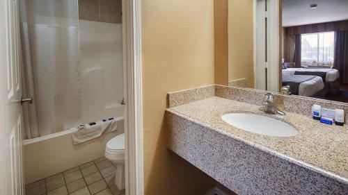 a bathroom with a sink and a toilet at SureStay Hotel by Best Western Sonora in Sonora