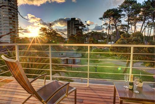 a patio with a table and chairs on a balcony at 2122 Hotel Art Design in Punta del Este