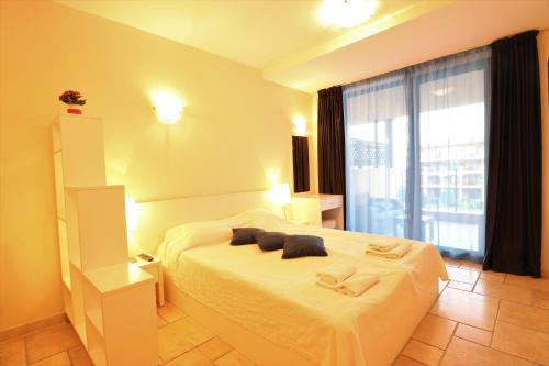 a bedroom with a bed and a large window at Kaliakria Sea View Apartments in Topola