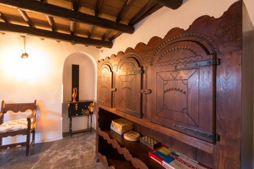 a large wooden cabinet in a room with books at Estalagem de Monsaraz in Monsaraz