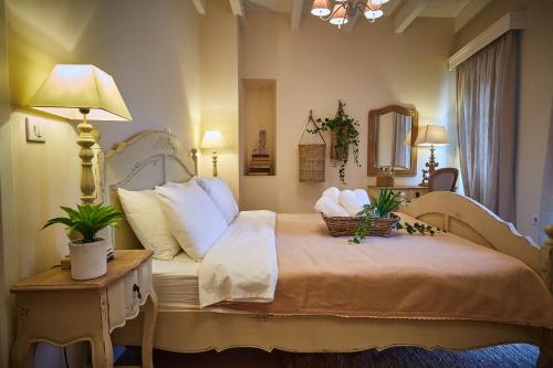 a bedroom with a bed with two plants on it at Lianelia LUXURY Village House in Argyrádes