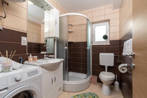 a bathroom with a shower toilet and a sink at Apartment Nives in Trogir