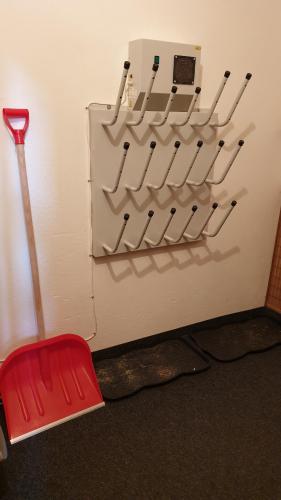 a room with a wall with a red chair and tools at Apartmán Abertamy in Abertamy