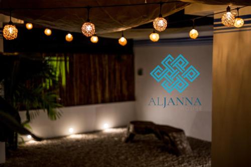 a room with a sign on a wall with lights at Aljanna House in Bacalar