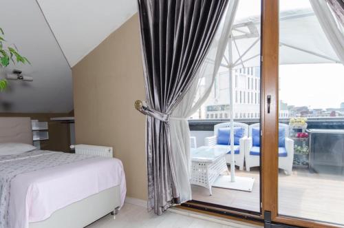 a bedroom with a bed and a large window at CTS Elysium Residence Taksim in Istanbul