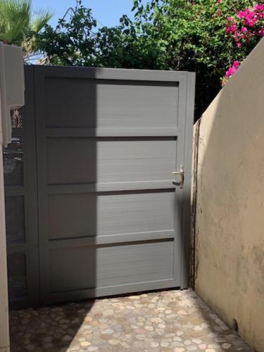 a garage door with a black and white at Villa Rena In Front of the Sea in Arkoudi