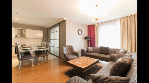 a living room with a couch and a table at CTS Elysium Residence Taksim in Istanbul