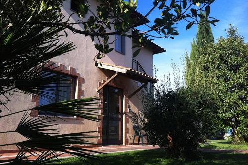 a house with a door on the side of it at Agriturismo Poggio alle Calle in Saturnia