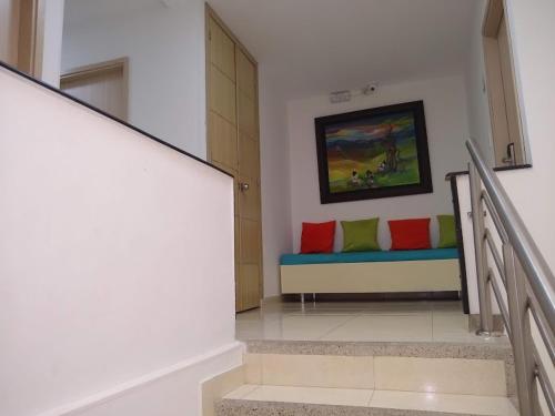 a hallway with a bench with colorful pillows on it at Hotel SGH Boutique Deluxe in Santa Marta