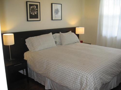 a bedroom with a large bed with two lamps at Resort Style In Aventura Florida in Aventura