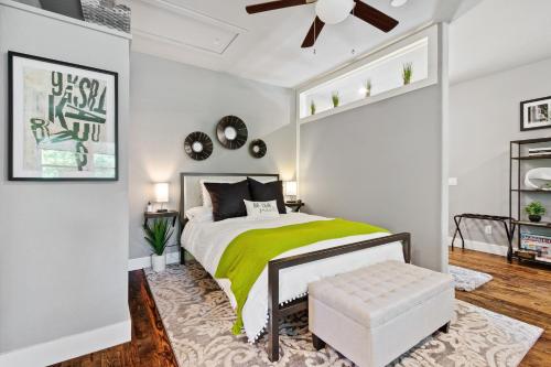 a bedroom with a bed with a green blanket at Studio A on Central Avenue in Bentonville