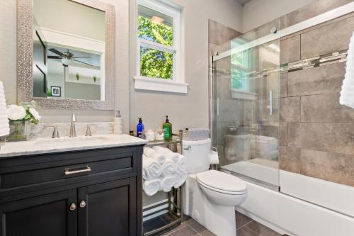 a bathroom with a sink and a toilet and a shower at Studio A on Central Avenue in Bentonville