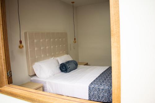 Postel nebo postele na pokoji v ubytování El Reloj Casa Hotel