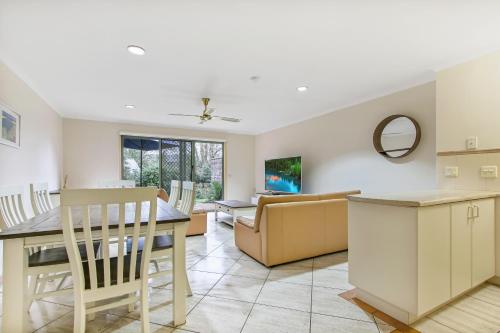 a kitchen and living room with a table and a couch at North Pier Hotel in Cowes