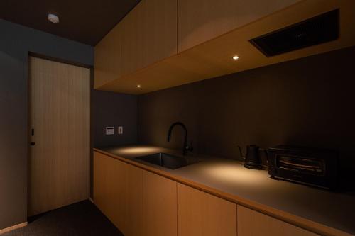 a kitchen with a sink and a counter top at Gunjo no Tsuki in Kanazawa