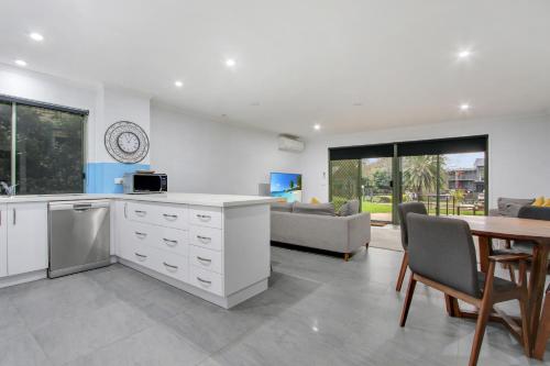 a kitchen and living room with a table and a couch at North Pier Hotel in Cowes