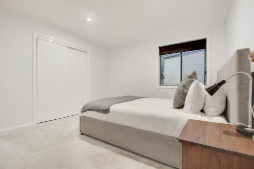 a bedroom with a bed with a desk and a window at North Pier Hotel in Cowes