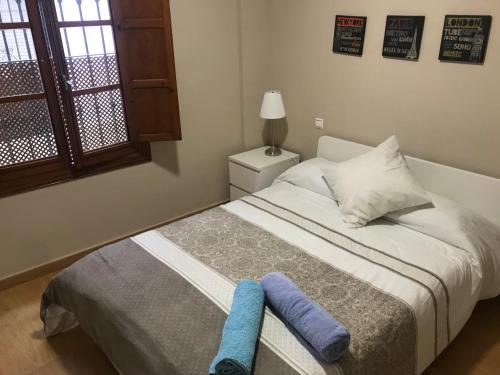 Un dormitorio con una cama con una toalla azul. en Apartamento en el centro para 4 personas, en Sevilla
