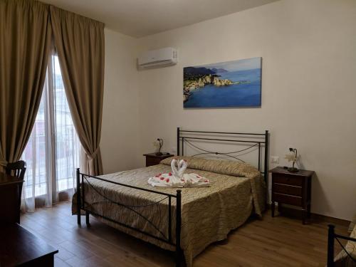 a bedroom with a bed and a large window at B&B Castiglione in Custonaci