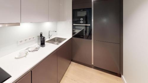 a kitchen with a white counter and a sink at White Pearl Apartment 1.15 in Timmendorfer Strand