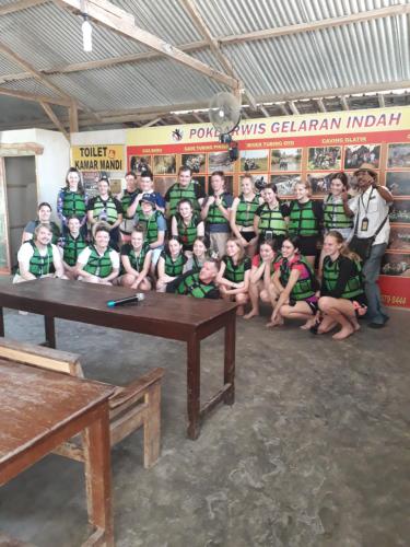 a group of people posing for a picture in a room at The New Orlinds Guest House in Wonosari