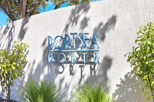 a sign on the side of a wall at Spinnaker Quays in Mooloolaba