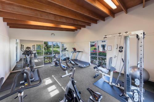 a gym with treadmills and elliptical machines at Ramada Resort By Wyndham Rotorua Marama in Rotorua