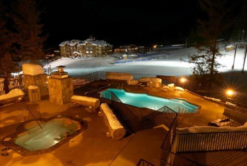 a swimming pool in the snow with a igloo at Snow Creek Cabins by Fernie Lodging Co in Fernie