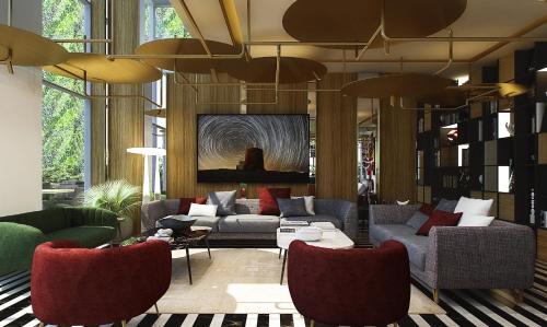 a living room with couches and red chairs at Swiss-Belboutique Bneid Al Gar Kuwait in Kuwait