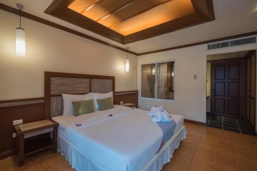 Кровать или кровати в номере Mac Resort Hotel