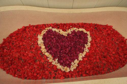 a heart made out of red flowers in a box at Ayuna Family Ubud in Ubud