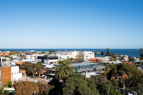 a city with buildings and the ocean in the background at Anchorage Apartments Hampton in Melbourne
