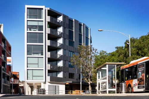a bus is parked in front of a building at Anchorage Apartments Hampton in Melbourne