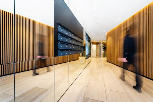 a hallway with people walking through a wine cellar at Anchorage Apartments Hampton in Melbourne