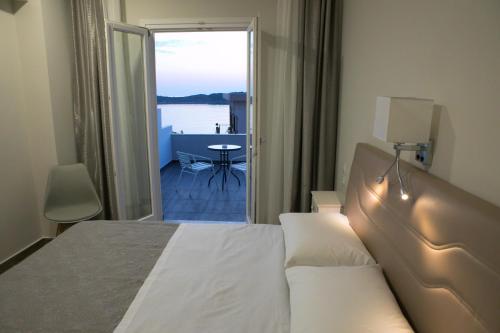 a hotel room with a bed and a view of the water at Hyperion Hotel in Myrties