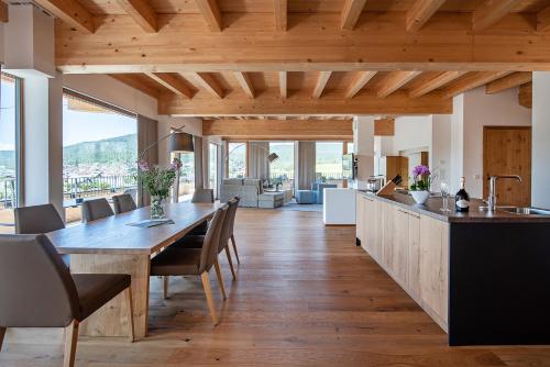 a kitchen and dining room with a table and chairs at GOTTHARD - FINE LIVING APARTMENTS in Seefeld in Tirol