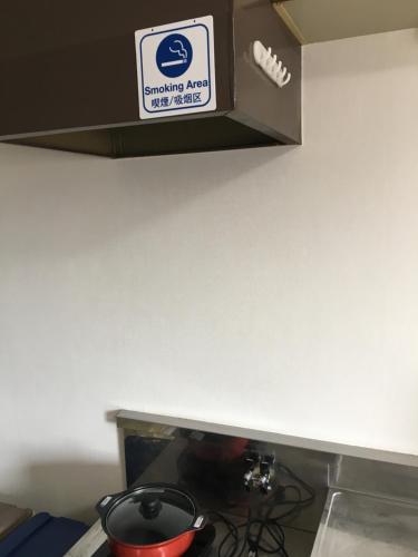 a kitchen counter with a box on top of a stove at コンドミニアムホテル Stay inn Blue in Hukue