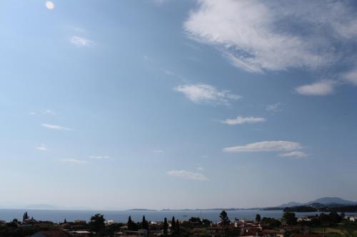 a view of a blue sky with clouds at Olive Luxury Rooms in Ýpsos