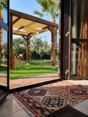 an open door to a patio with a view of a yard at Villa Antonella in Carlentini